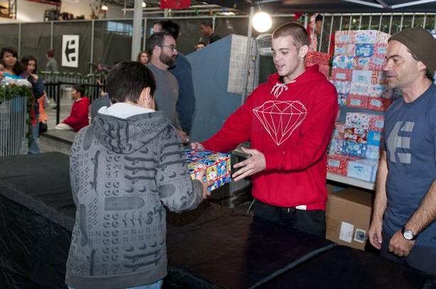 Ryan Sheckler hands out shoes to kids.