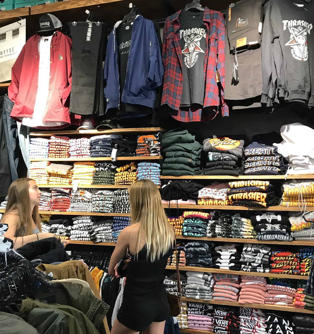 Teenage girls picking out Thrasher T's at Zumiez - Photo by SES