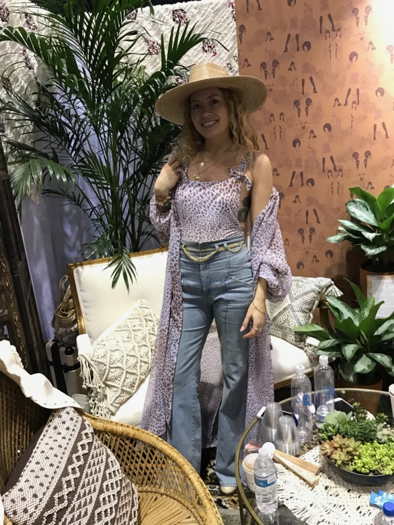 A Power 2 the Flower one piece and coverup worn with high-waisted denim