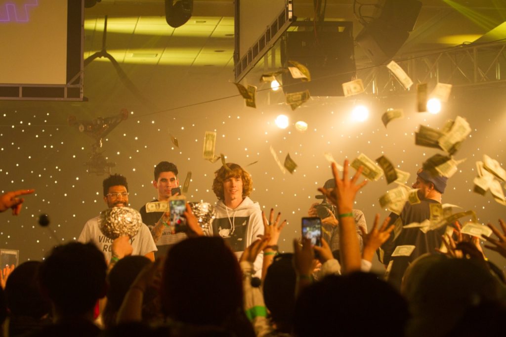 Danny Duncan of Virginity Rocks throwing money to Zumiez employees - Photo courtesy of Zumiez