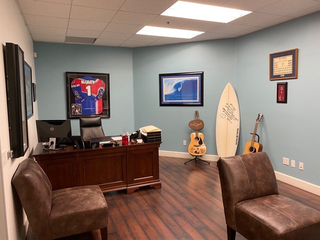 Joe Schaefer’s office is packed with mementos that trace the rise of the industry. Around his desk: An early Hurley brand board signed by Bob Hurley, “Hey Joe, As you know … Innovative is the only way to be! Thanks for helping us be who we are 😀”; a framed and signed photo of Conan Hayes in heavy water, from early in RVCA days; and, a framed and signed Jeremy McGrath Moto jersey, early days of No Fear