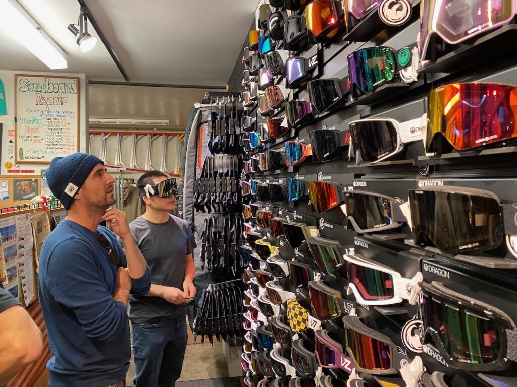Liam Barrett of 100% helping a shopper pick goggles