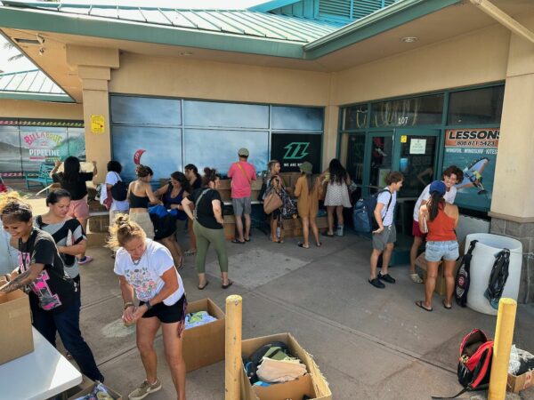 Hi Tech delivery driver Kahea Corpuz & Hi Tech accessory buyer Alyssa Villon flank Lahaina locals who received new clothing & bags. Hi Tech delivery driver Kahea Corpuz & Hi Tech accessory buyer Alyssa Villon flank Lahaina locals who received new clothing & bags.