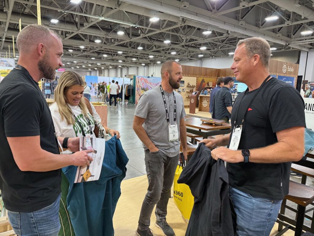 Brian Sanders, right, of Sand Cloud showing Sand Cloud's towels to Goode Ski Technologies. Photo by SESO.