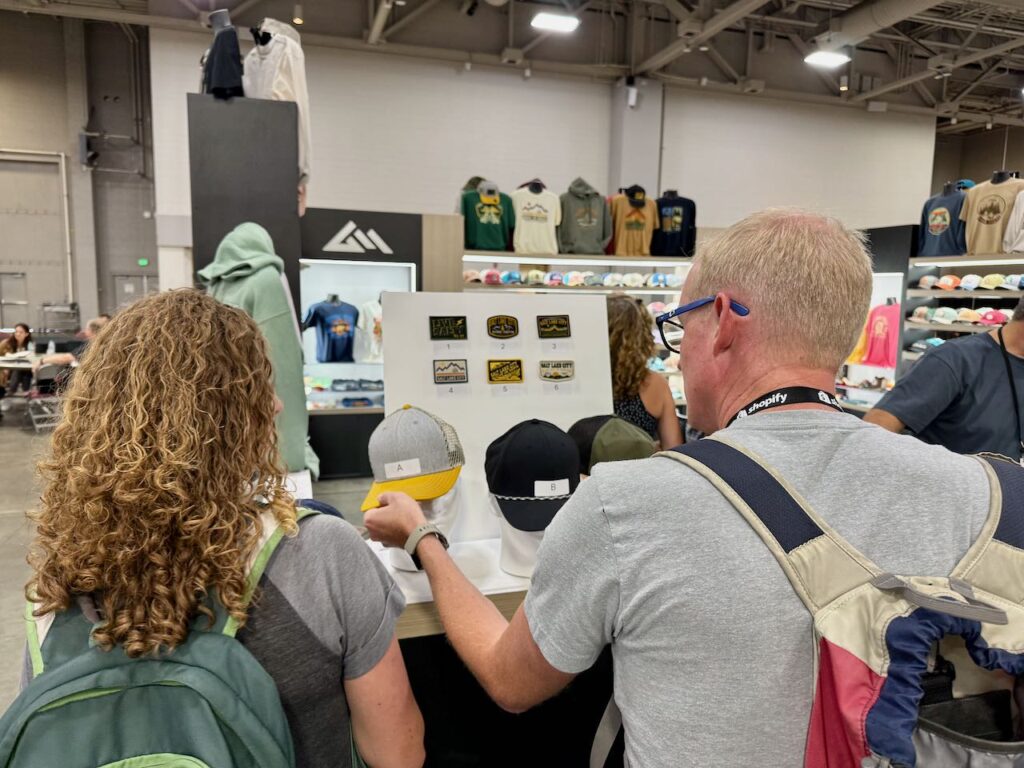 Retailers checking out Great Mountain West hats. Photo by SESO.