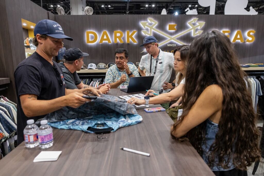 Coastal Edge talking business at Dark Seas. Photo courtesy of Surf Expo. 