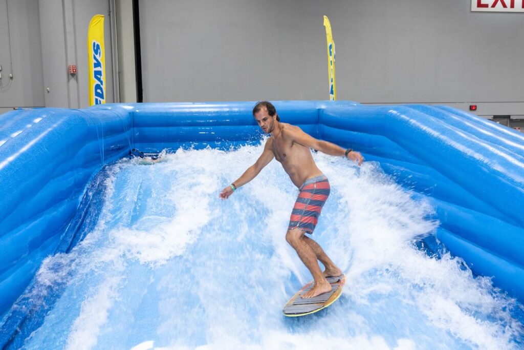 "Surfing" on the show floor with Wave Rider by Surf Days. Photo courtesy of Surf Expo.
