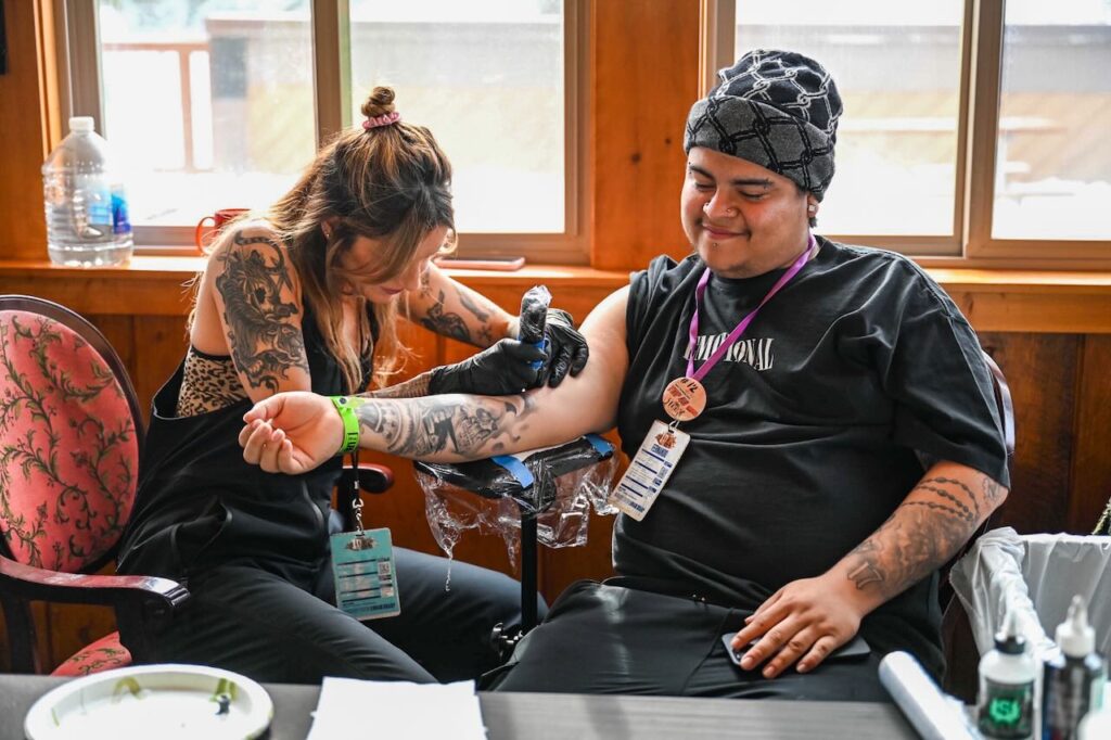 The brand lurking class brought a tattoo artist to the 100k celebration. Photo courtesy of Zumiez. 