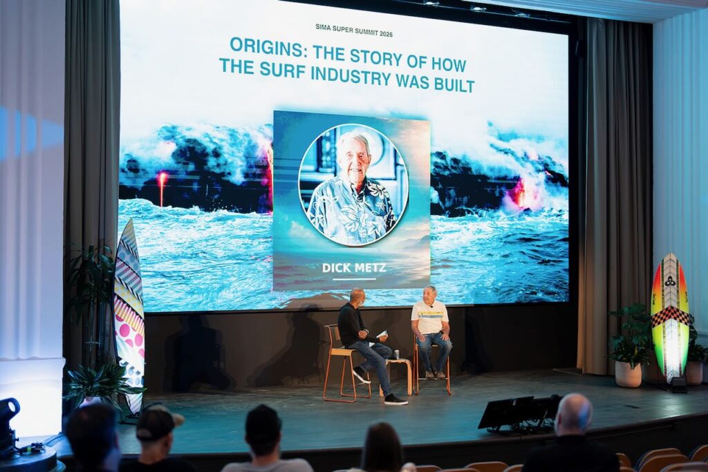 Surf Industry Members Association Executive Director Vipe Desai speaks with surf pioneer Dick Metz during "Origins: The Story of How the Surf Industry Was Built" at the 2026 SIMA Super Summit in Laguna Beach. Photo by Dipan Desai Photography.